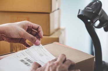 Home delivery service and working service mind, Woman working install serial barcode to confirm before sending customer in post office.