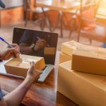 Delivery driver picking up shipment from eCommerce retailer's location