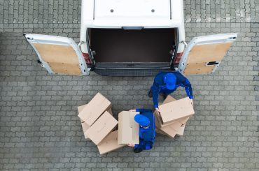 Man unloading truck of packages after visiting multiple warehouses