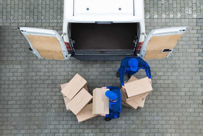 Multi-Warehouse Management: How to Manage Shipping Rates for Multiple Warehouses Man unloading truck of packages after visiting multiple warehouses