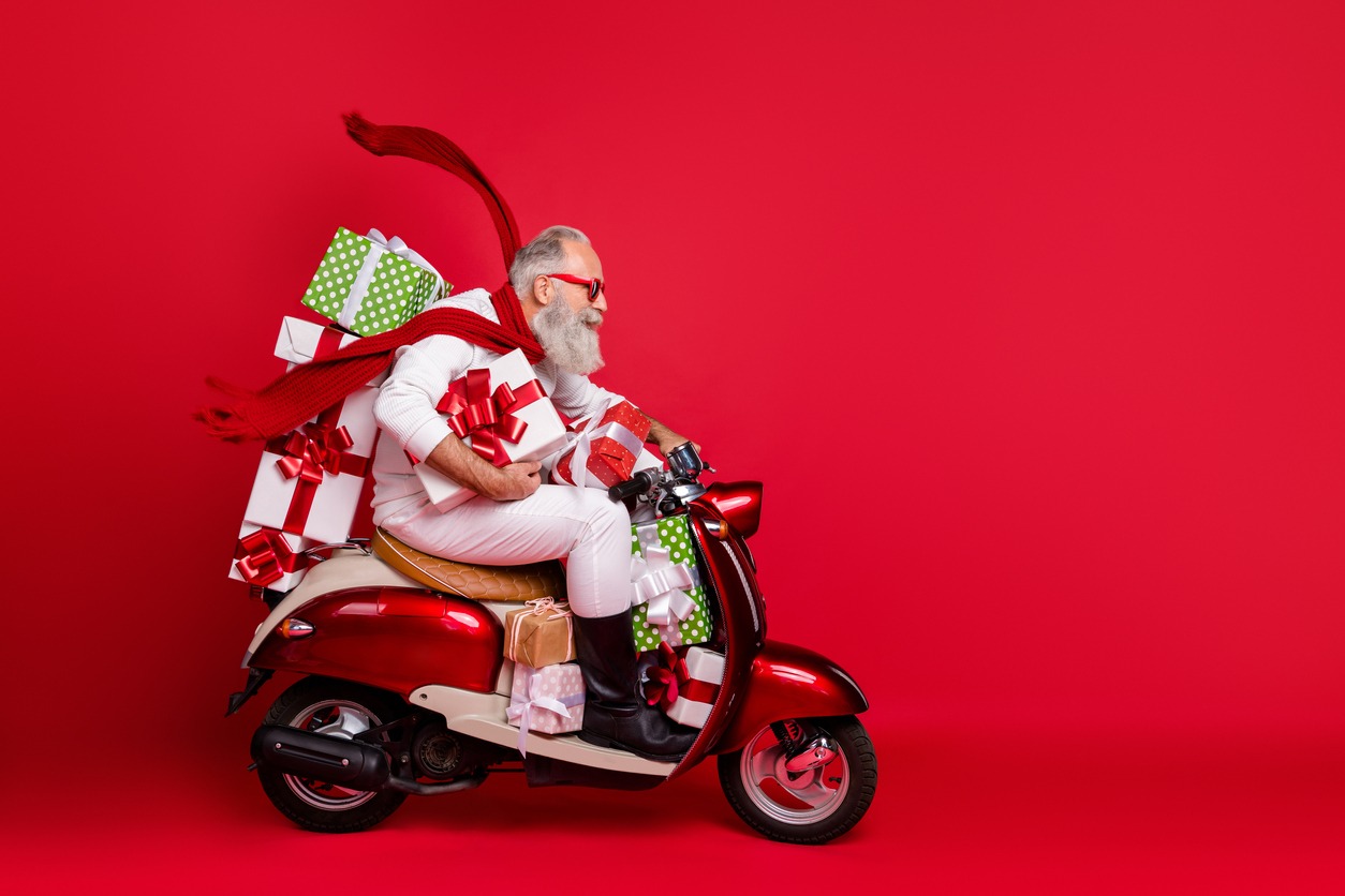 2022 Holiday Shipping Cutoff Dates: What You Need to Know Profile side view of hip Santa riding on a scooter