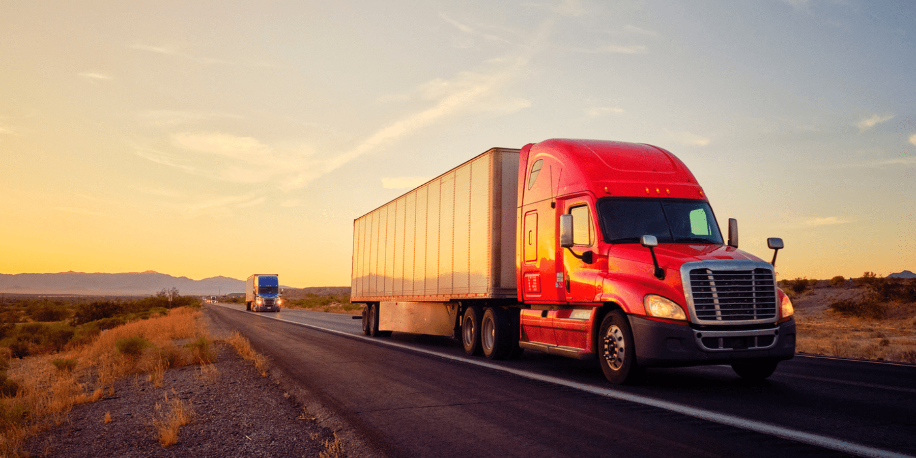 From YRC to K+N: Unpacking the Advantages for Your Freight Needs Long haul freight truck driving across the desert at sunset